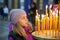 Little girl with candles in Orthodox Russian Church