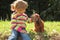 Little girl caress dachshund outdoor