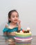 Little girl celebrating her birthday at home during quarantine. Wearing arabian princess costume