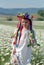 Little girl on chamomile field