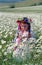 Little girl on chamomile field