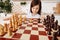 Little girl changing a perspective on a chessboard