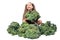 Little girl cheerfully holding head of broccoli and smiling