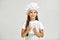 Little girl in chef hat and apron with flour in measuring cup.