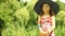 Little girl child kid putting on straw hat outdoor