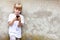 Little girl, child using a modern smartphone standing outdoors. Kid alone focused on her mobile phone, copyspace