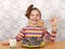 Little girl with chocolate donuts and ok hand sign