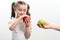 Little girl chooses between two apples, red or green apple, child& x27;s choice