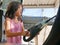 Little girl cleaning a car using a portable handheld vacuum cleaner