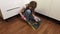 Little girl cleaning floor in kitchen