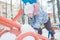 Little girl climbing on snowy playground seesaw