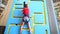 Little girl climbing a wall indoor