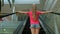 Little girl climbs the escalator in the Mall