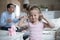 Little girl close ears refuse to hear family fight