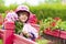 The little girl close in a pink hat and a raincoat.