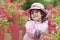 The little girl close in a pink hat and a raincoat.