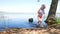 Little girl comes out of the lake, holding the dresses