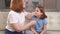 the little girl complains of a sore throat and her mother examines it.