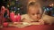 Little girl composing wish list before christmas holidays, waiting for presents