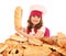 Little girl cook holding bread