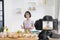 Little girl cooks in the kitchen at home, With recording making video blogger camera