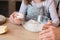 Little girl cracking egg to bowl, helping father with cooking pastry