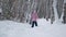 Little Girl Cross Country Skiing in Winter Forest