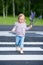 Little girl crossing road