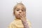 A little girl in a crown demonstrates toy rings on her fingers, children`s jewelry and bijouterie.