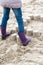 Little girl crushing mud pies