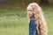 Little girl with curly hair feeling sadness - outdoor portrait