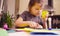 Little girl cutting birds from yellow paper