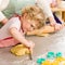 Little girl cutting dough for cookies