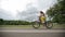 Little girl cycling in park on a pink bike. Slow motion