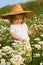 Little girl on the daisy field