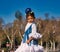 a little girl dancing flamenco dressed in a white dress with ruffles and blue fringes in a famous square in seville, spain. The