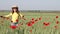 Little girl dancing in green wheat field