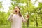 Little girl with dandelions suffering from seasonal allergy on sunny day