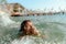 Little girl in danger drowning at the ocean