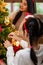 Little girl decorate christmas tree with ornament