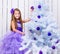 Little girl decorated Christmas tree