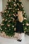 little girl  decorates a Christmas tree