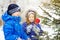 Little girl decorates the Christmas tree.