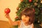 Little girl decorates Christmas tree