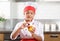 Little girl decorates a cupcake berry