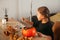 A little girl decorates a pumpkin in a room for Halloween. Kids decorate home. Children carve pumpkin. Spooky Halloween fun