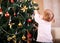 Little girl decorating Christmas tree