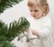 Little girl decorating Christmas tree