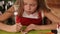 Little girl decorating gingerbread christmas cookies