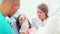 Little girl and dental assistant doing high-five after teeth checkup